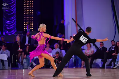 Dancesport competitor #715: Male dancer: black long-sleeved shirt and black trousers