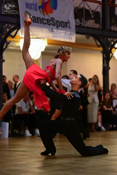 Dancesport competitor: Female dancer: red Latin dress