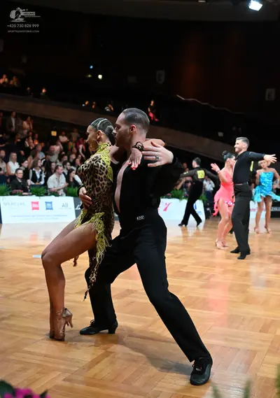 Dancesport competitor: Foreground female dancer: leopard-print latin dress