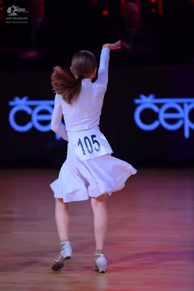 Dancesport competitor: Female dancer: white long-sleeved dress with a flared skirt