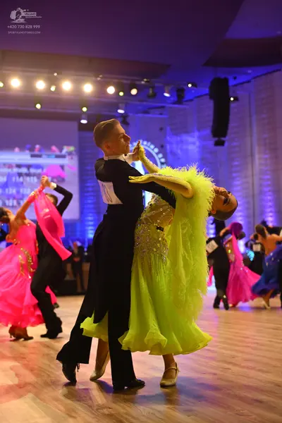 Dancesport competitor: Male dancer: black ballroom suit with a white shirt and stiff collar