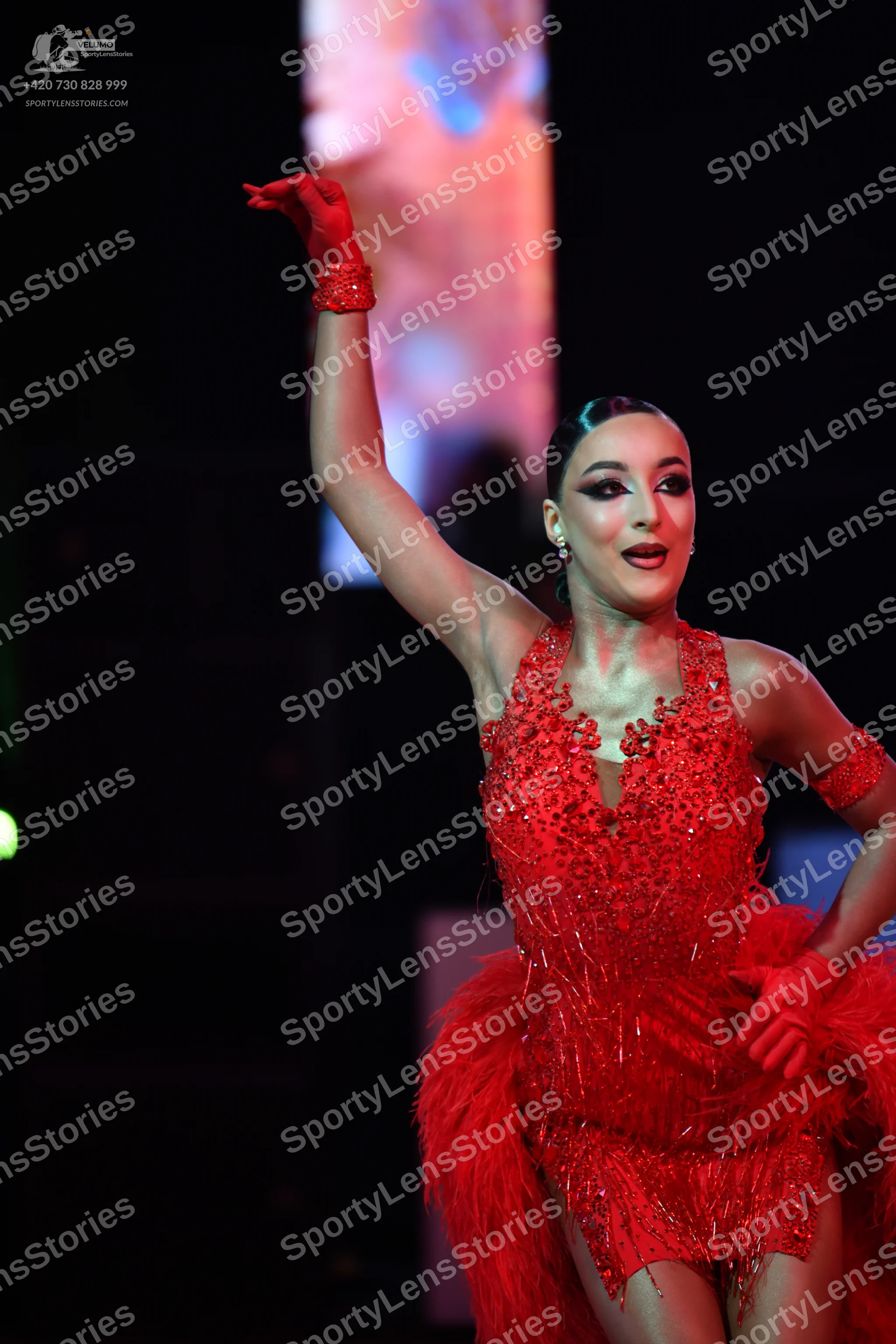 Dancesport competitor: Female dancer: red Latin dance dress with heavy sequin and bead embellishments,