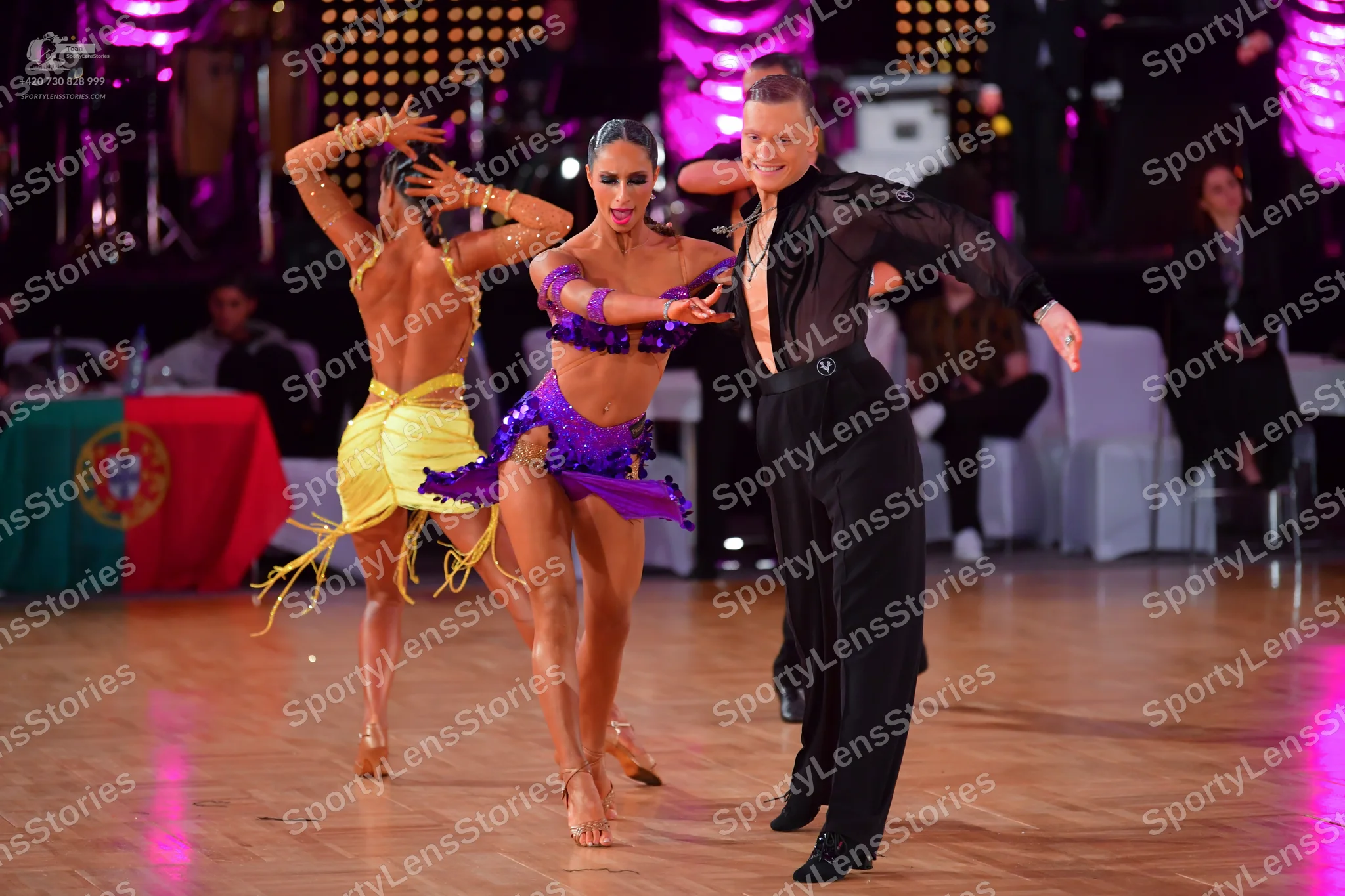 Dancesport competitor: Male dancer: black long-sleeve shirt with sheer mesh and black trousers