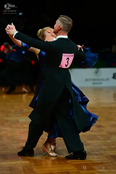 Dancesport competitor: Male dancer: black tailcoat and black trousers