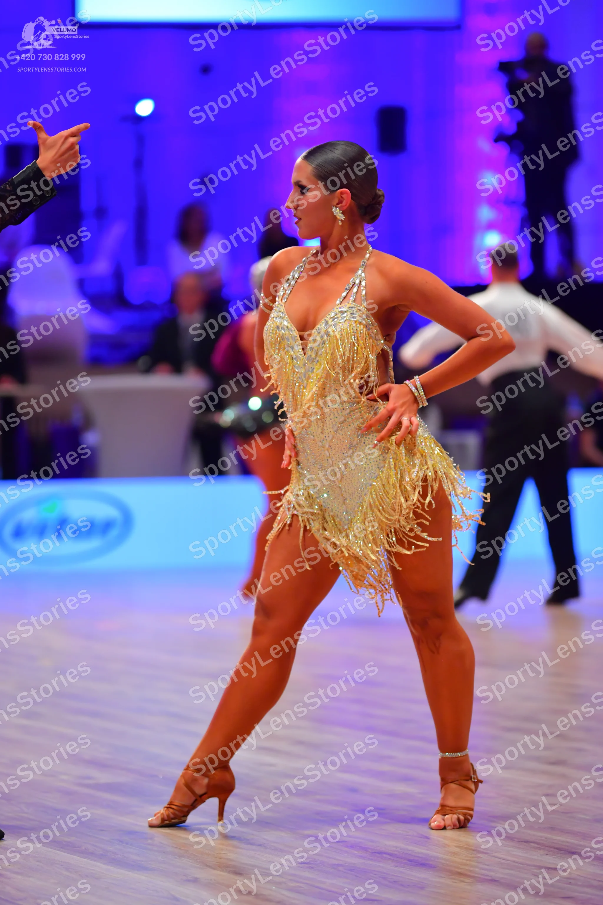 Dancesport competitor: Female dancer: cream Latin dress with sequins and fringe