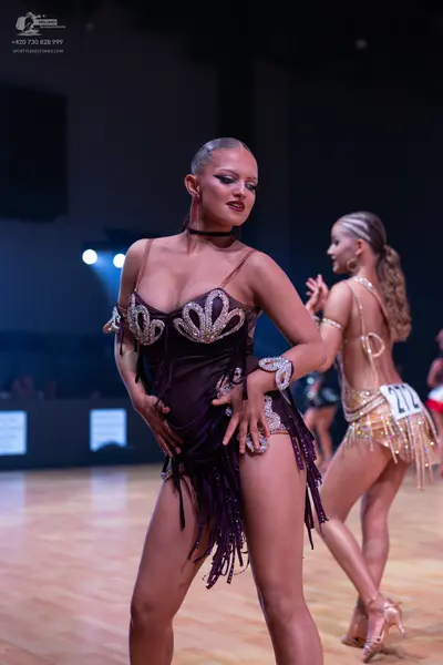 Dancesport competitor: Female dancer 1: dark brown latin dress with silver sequin embellishments and lo