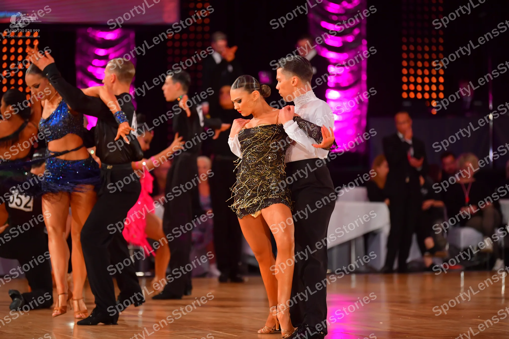 Dancesport competitor #652: Male dancers: black long-sleeved shirts and black trousers, and one white long-s