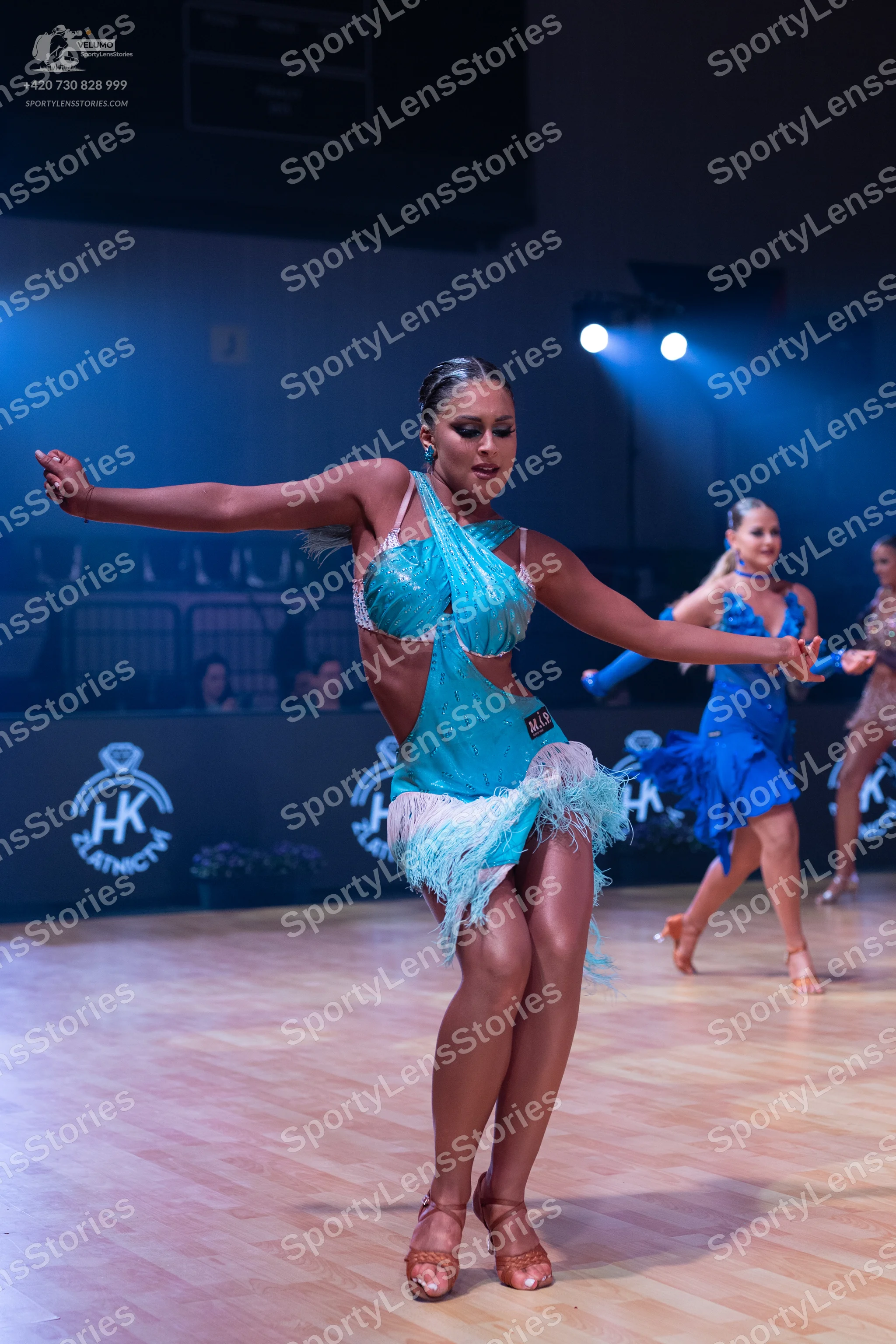 Dancesport competitor: Female dancer 1: aqua Latin dance dress with sequins and fringe