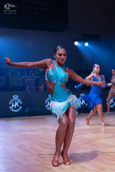 Dancesport competitor: Female dancer 1: aqua Latin dance dress with sequins and fringe