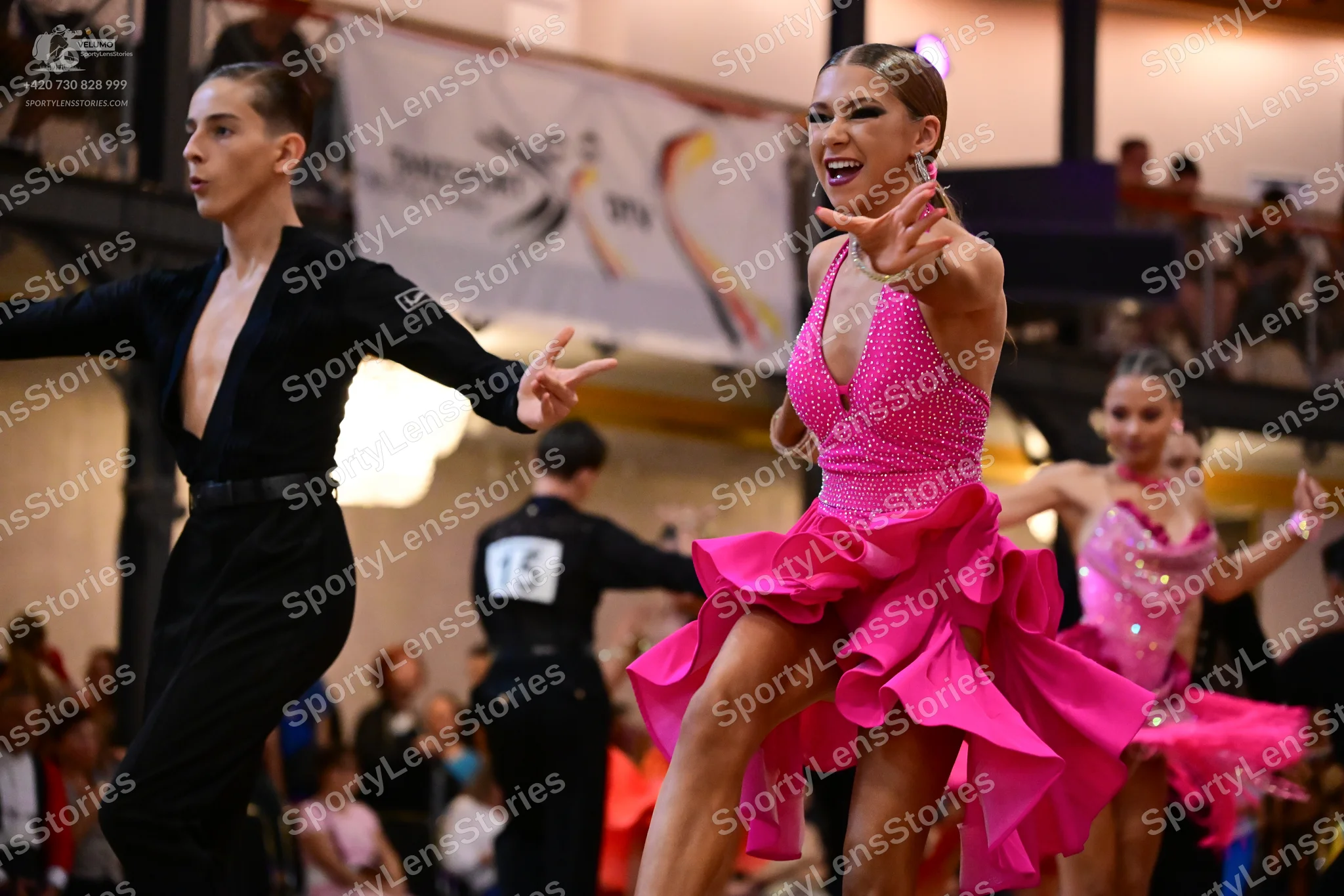 Dancesport competitor #15: Male dancer (foreground): black long-sleeved top and black trousers