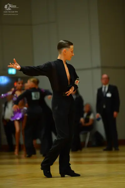 Dancesport competitor: Male dancer: black long-sleeved shirt and black trousers