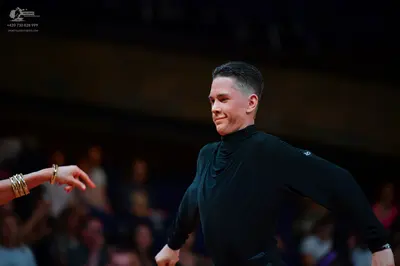 Dancesport competitor: Male dancer: black long-sleeved high-neck top