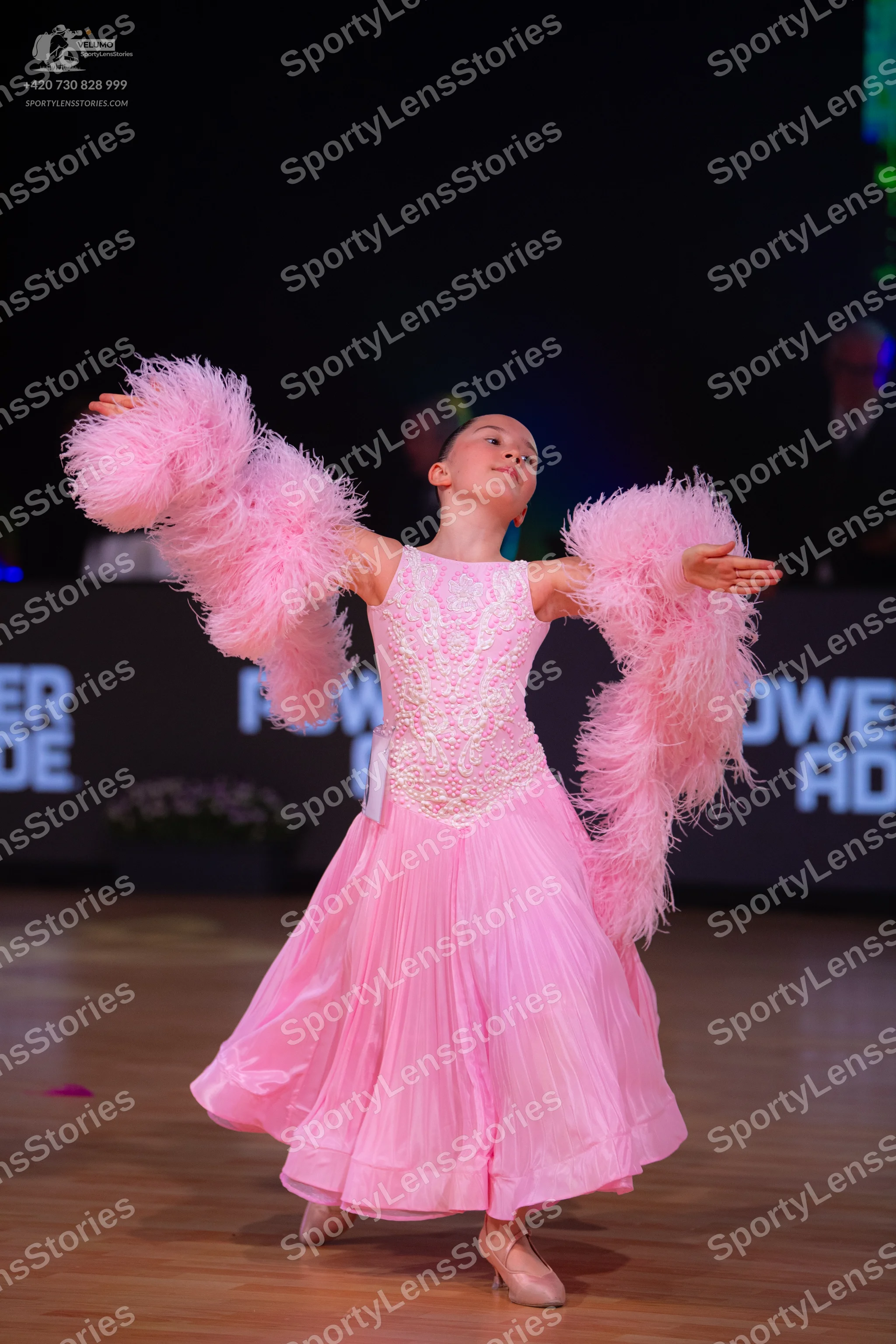 Dancesport competitor: Female dancer: pink ballgown with a lace/sequined bodice, a voluminous flowing s