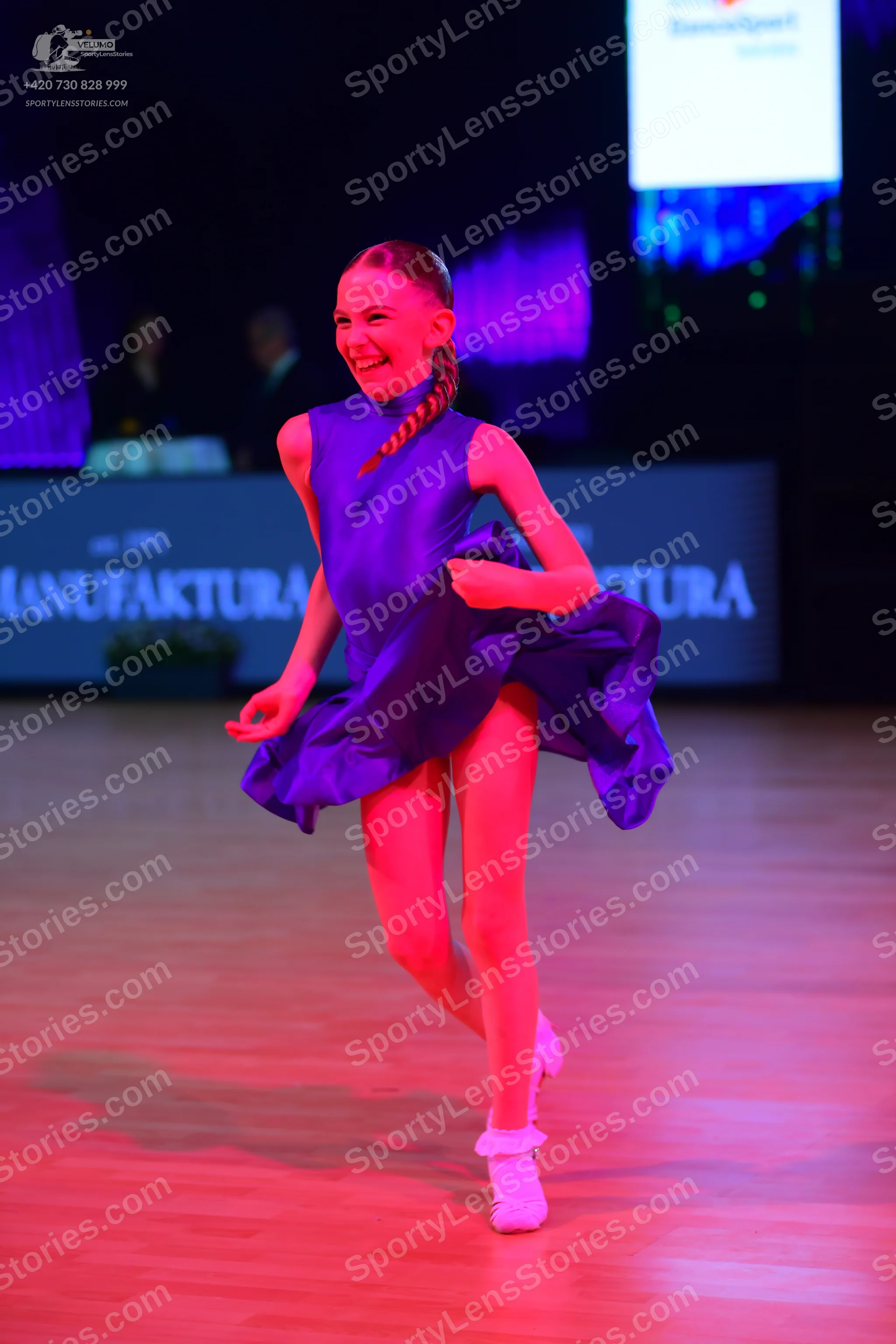 Dancesport competitor: Female dancer: purple sleeveless Latin dance dress with a flared skirt, made of 