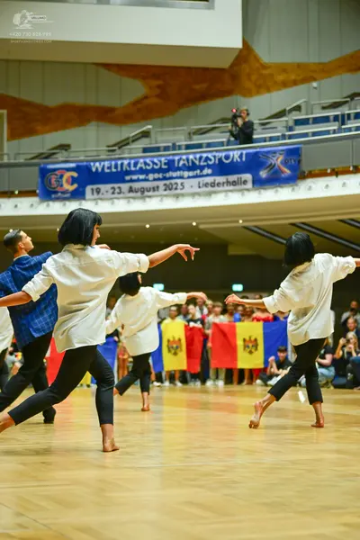 Dancesport competitor: Male dancer: blue patterned shirt and black trousers