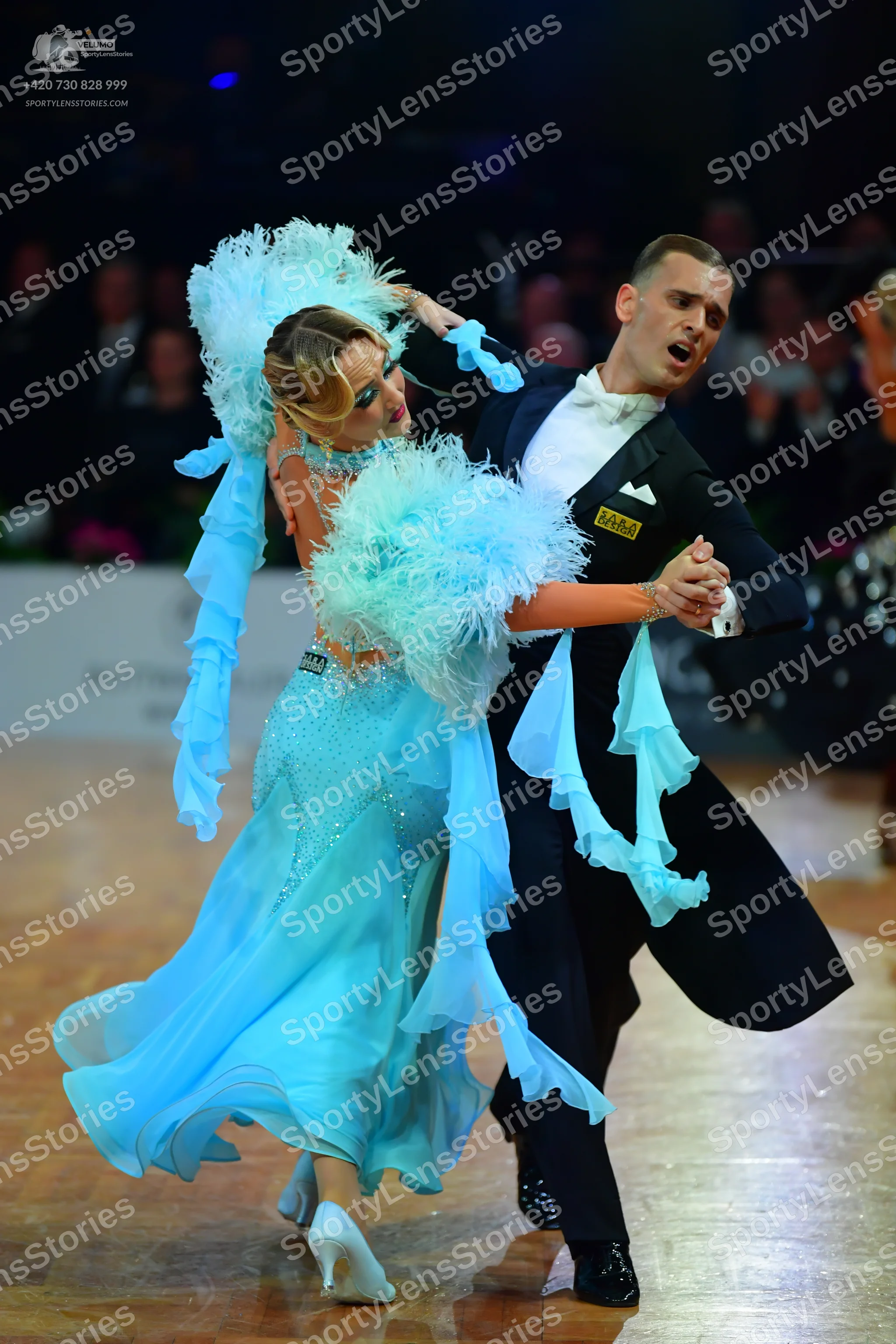 Dancesport competitor: Male dancer: black ballroom suit with a white shirt and white bow tie