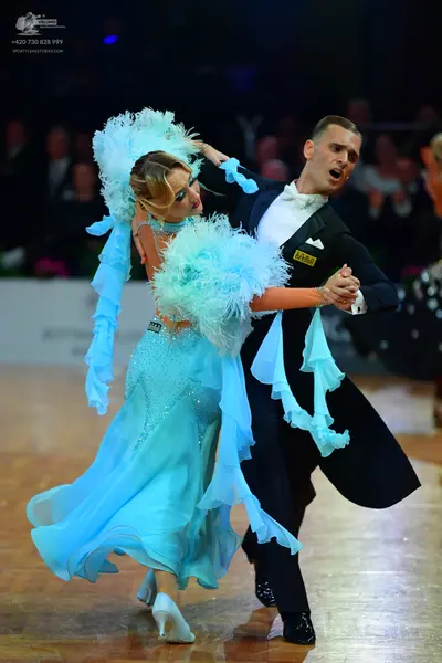 Dancesport competitor: Male dancer: black ballroom suit with a white shirt and white bow tie