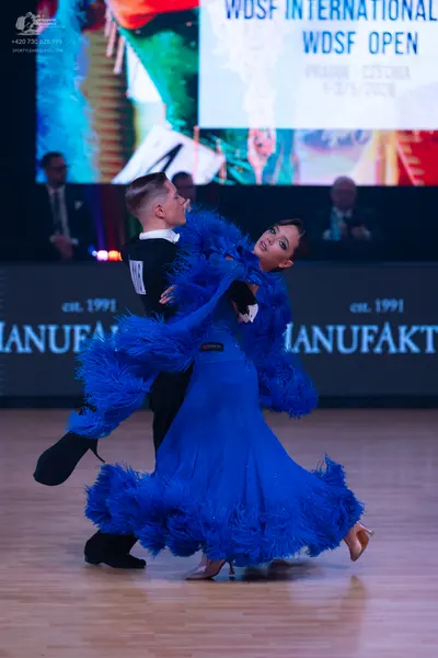 Dancesport competitor: Male dancer: black waistcoat, white shirt, black bowtie, and black trousers