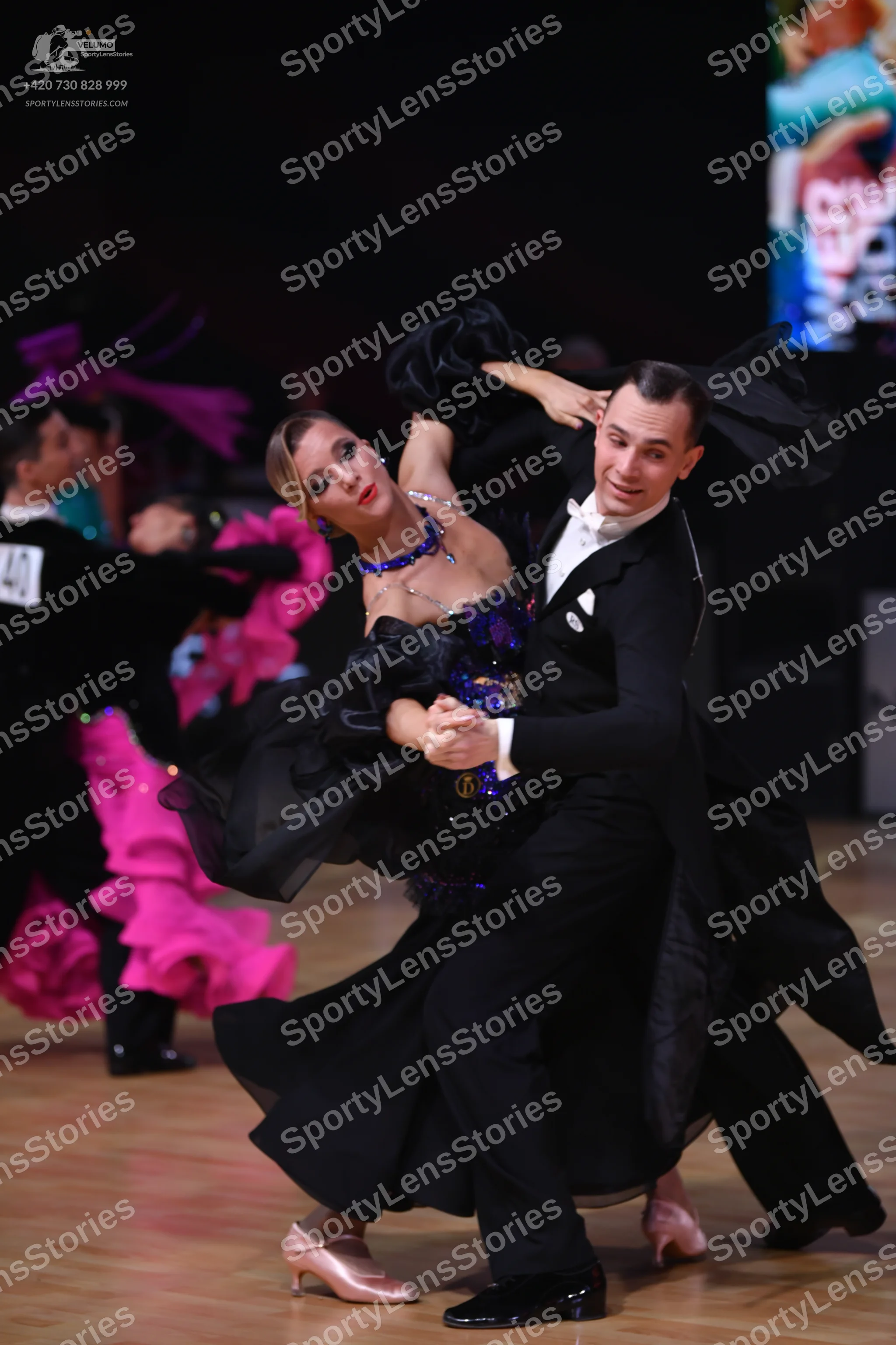 Dancesport competitor: Male dancer on left: black suit