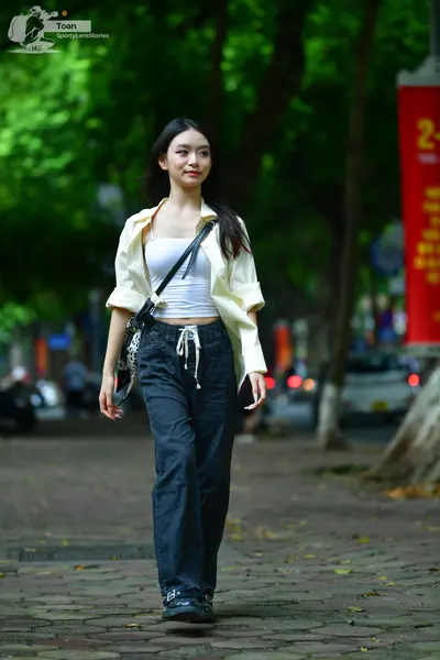 Dancesport competitor: Female dancer: white button-up shirt worn open over a white crop top, dark grey 