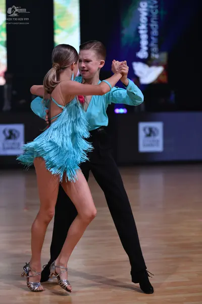 Dancesport competitor: Female dancer: aqua blue Latin dress with long fringe and thin straps
