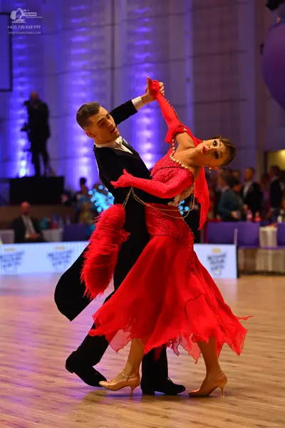 Dancesport competitor: Male dancer: black suit with a white shirt and black bow tie