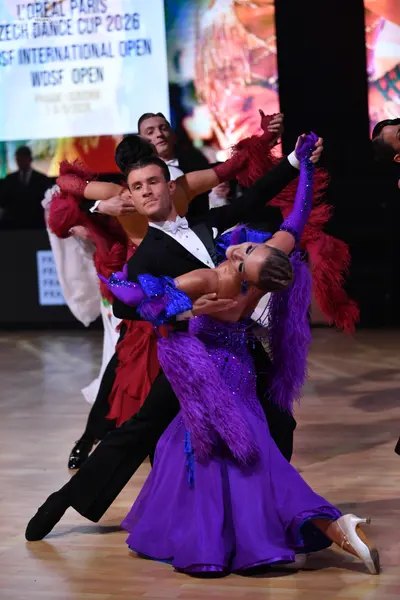 Dancesport competitor: Male dancer: black suit with a white shirt and white bow tie