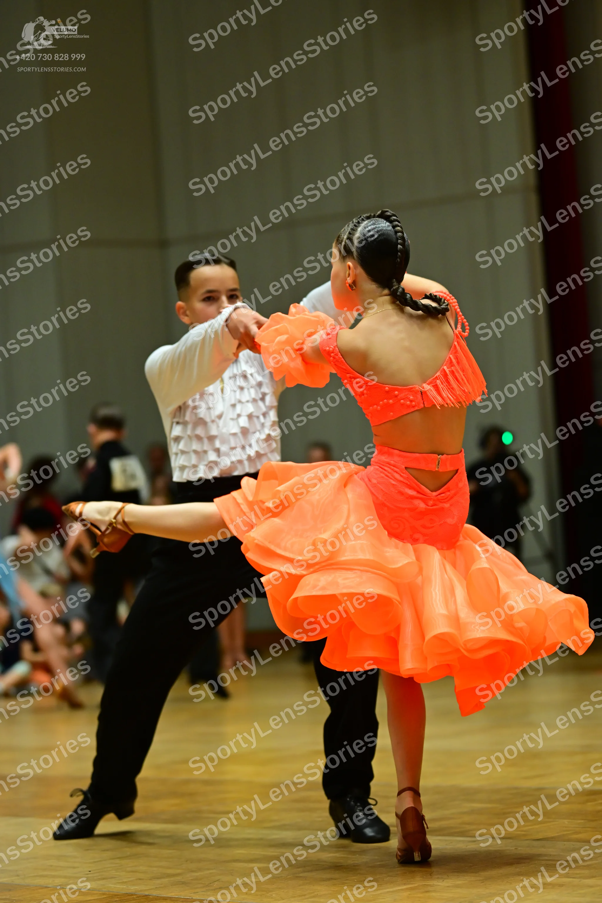 Dancesport competitor: Male dancer: white long-sleeved shirt with a ruffled front and black trousers
