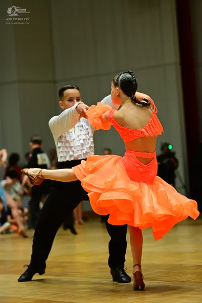 Dancesport competitor: Male dancer: white long-sleeved shirt with a ruffled front and black trousers