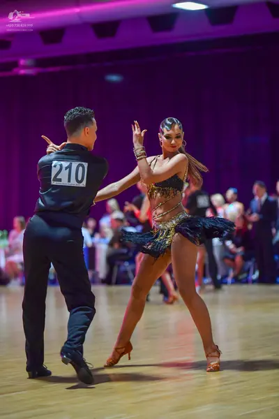 Dancesport competitor #210: Male dancer: black long-sleeved shirt and black trousers