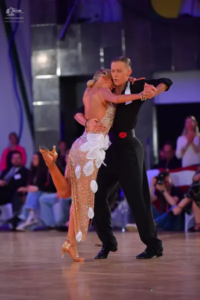 Dancesport competitor: Male dancer: black long-sleeved shirt and black trousers