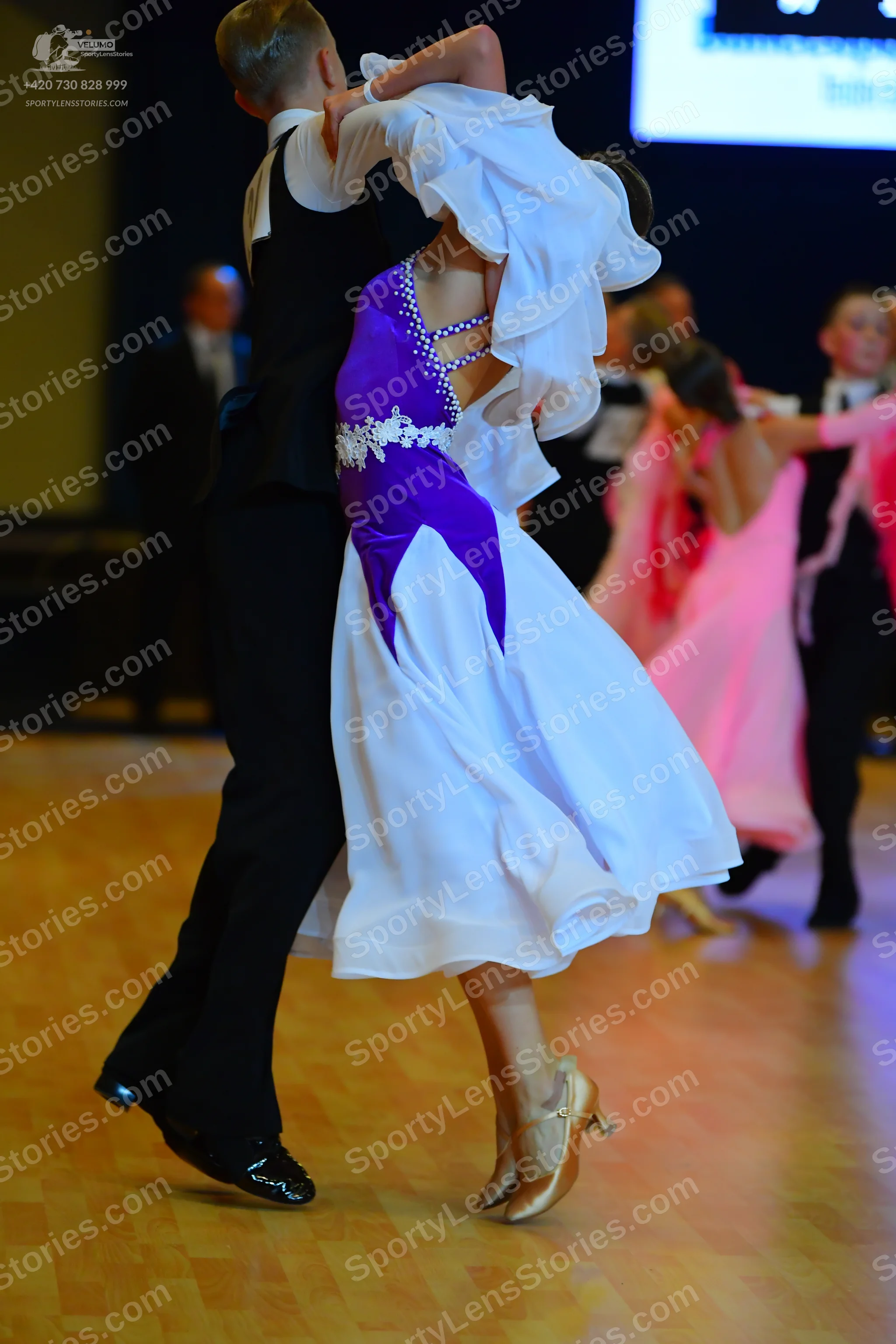 Dancesport competitor: Male dancer: black suit with a white waistcoat and white shirt, and black dance