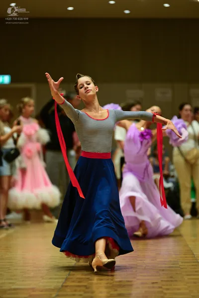 Dancesport competitor: ** Red Latin dress
*   **Fabric:** Satin (likely)
*   **Style:** Latin dress - F