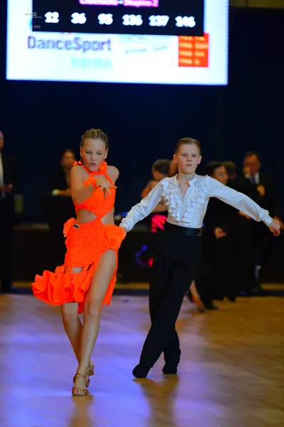 Dancesport competitor #999: Male:** Black suit with a sequin lapel and black shoes