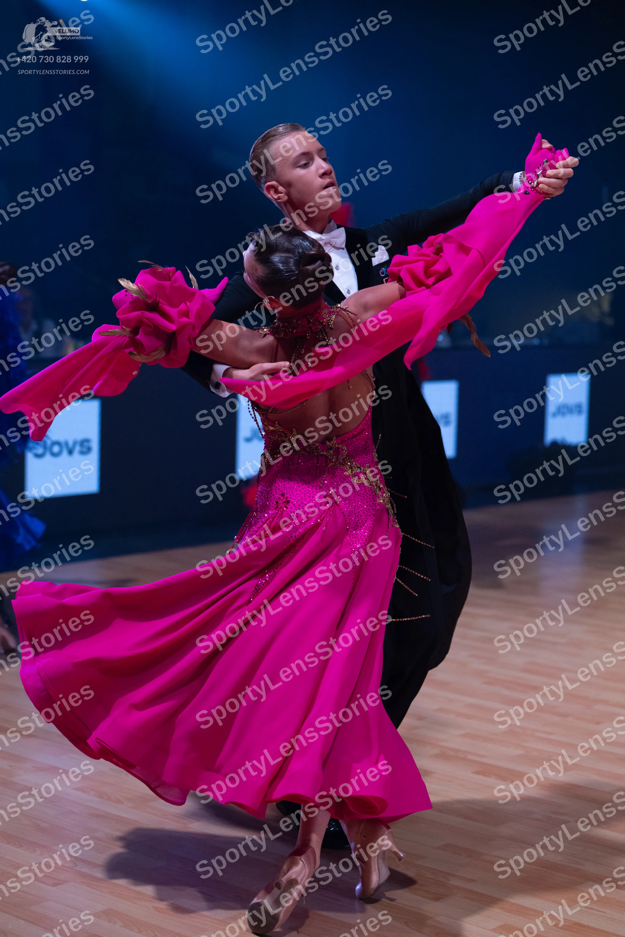 Dancesport competitor: Male dancer: black tuxedo with a white shirt and black bow tie