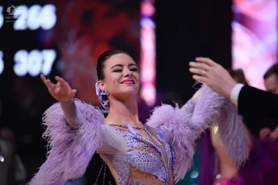 Dancesport competitor: Female dancer: light purple/lavender dress with large feather trim on the sleeve