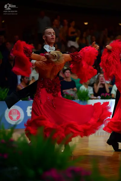 Dancesport competitor: Male dancer: black suit with a white shirt and white bow tie