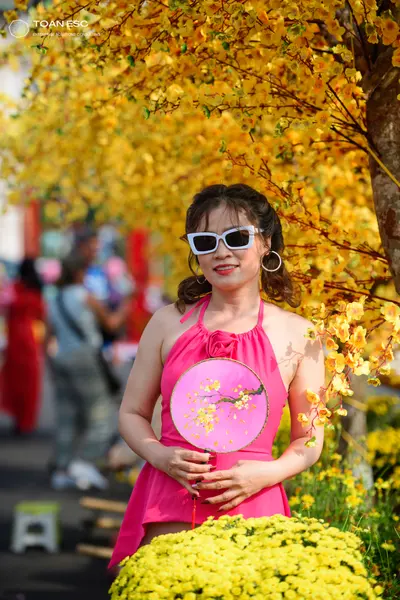 Dancesport competitor: Female dancer: pink latin dress with a halter neck and a floral detail on the ch