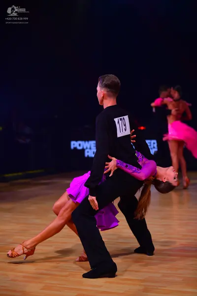 Dancesport competitor: Male dancer: black long-sleeved shirt and black trousers