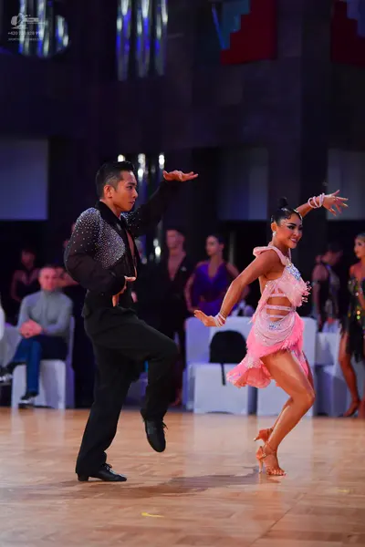 Dancesport competitor: Male dancer: black long-sleeved shirt with small sequins on the shoulders and bl