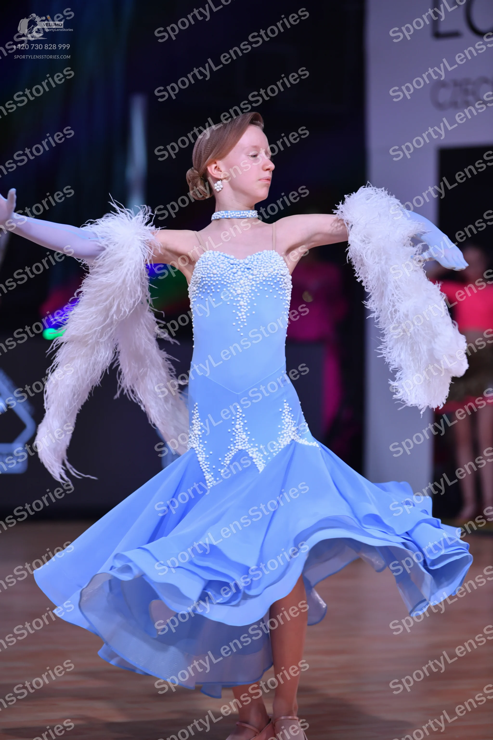 Dancesport competitor: Female dancer: light blue ballroom dress with white/silver sequin/crystal embell