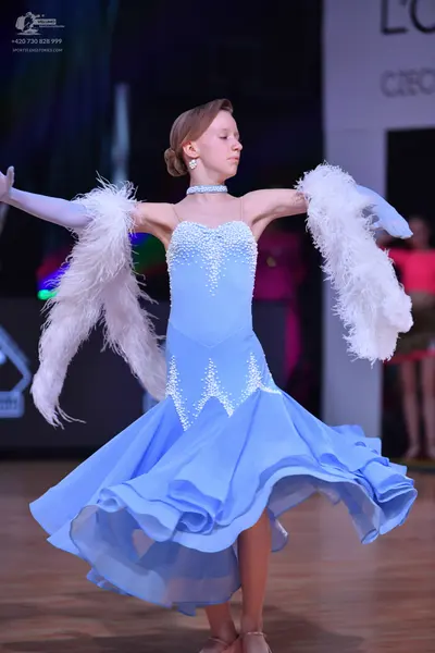 Dancesport competitor: Female dancer: light blue ballroom dress with white/silver sequin/crystal embell