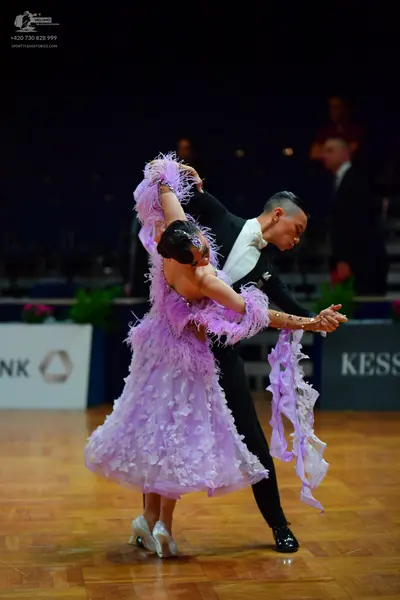 Dancesport competitor: Male dancer: black suit with a white shirt and white bowtie