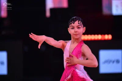 Dancesport competitor: Female dancer: pink and white Latin dress with fringe