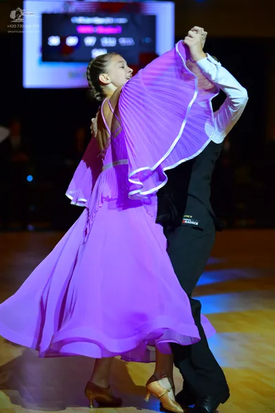Dancesport competitor: Male dancer: white long-sleeved shirt and black trousers