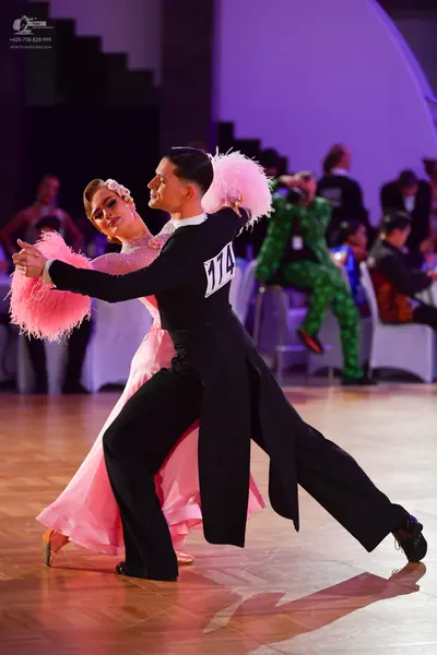 Dancesport competitor #174: Male dancer: black long-sleeved tailcoat and black trousers