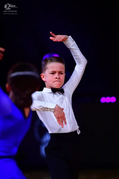 Dancesport competitor: Male dancer: white long-sleeved shirt, black trousers, and a black bow tie