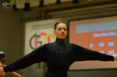 Dancesport competitor: Main dancer: black long-sleeved high-neck top with small shimmering embellishmen
