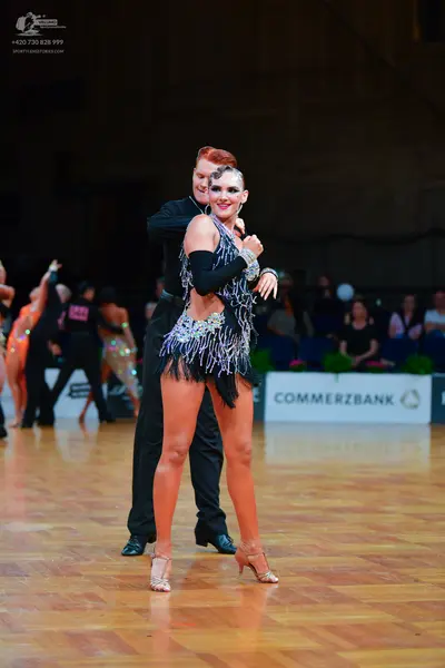 Dancesport competitor: Male dancer: black long-sleeved shirt and black trousers