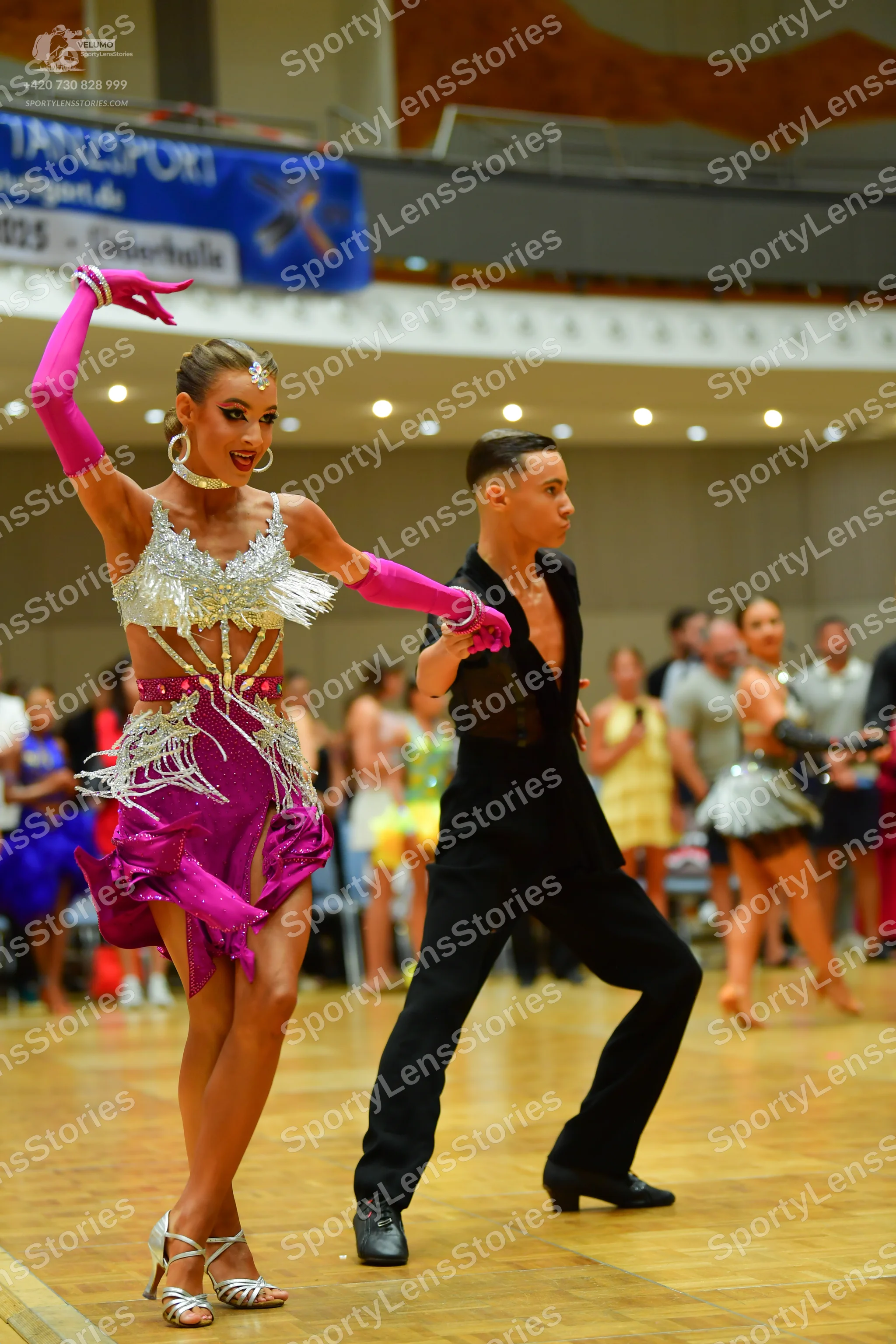 Dancesport competitor: Male dancer: black latin dance shirt and black trousers with black dance shoes